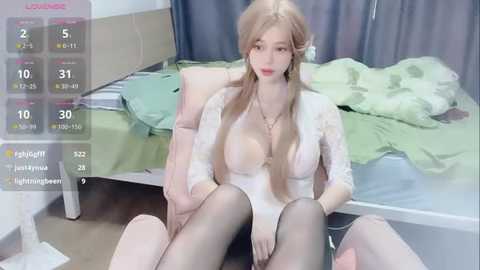 Media: A highly realistic CGI image of a young blonde woman with pale skin, large breasts, and black stockings, sitting on a bed with a disheveled green and white duvet. The image is overlaid with a virtual reality interface displaying stats and options.