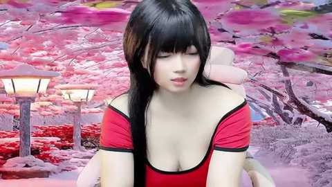 Media: Video of an Asian woman with long black hair, fair skin, and a red off-shoulder top, sitting in a serene cherry blossom garden with blooming pink trees, stone lanterns, and a serene pond.