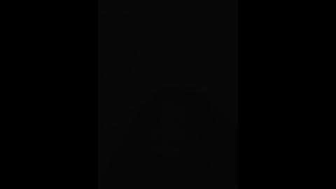 Media: Video of a black wall with a vertical white stripe in the middle, creating a stark contrast between the two colors. The image is minimalist and abstract, focusing on the simple interplay of light and dark.