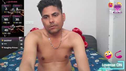 Media: A video of a shirtless, light-skinned man with short black hair, wearing a silver chain necklace, sitting on a blue bed with cartoon characters. The background shows a video screen with stats and a \"Loves ON\" watermark.