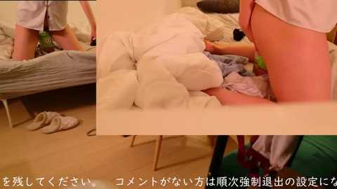 Media: Video of a messy bedroom with a woman in a white shirt and black panties, lying on a bed. Clothes scattered on the floor. Japanese text overlaid.