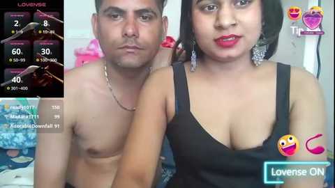 Media: A video of a shirtless man and a woman with short black hair, both wearing black clothing, taken in a bedroom setting.