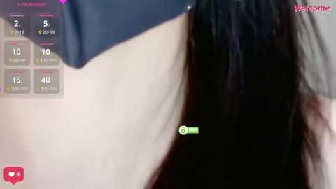 A close-up video of a woman's neck and shoulder, showing light skin and black hair. A blue top is partially visible. A green icon with a \"+\" symbol is overlaid on the image.