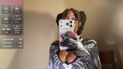 A video shows a dark-skinned woman with large breasts, wearing a plaid shirt, taking a selfie in a dimly lit room. The background is plain and the image includes a social media app screen with user information.