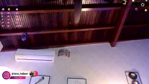 Video of a modern interior featuring a wooden ceiling with air conditioning, light fixtures, and framed art on a light blue wall.