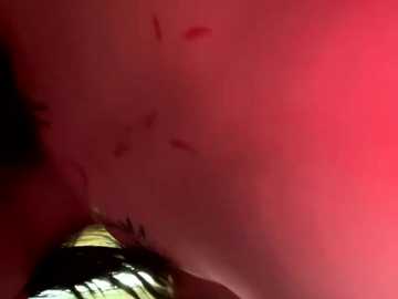 A close-up video of a red surface with several dark spots, possibly indicative of blood or other organic material, captured from an angle that emphasizes texture and depth.