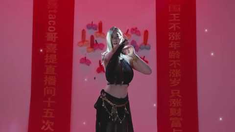 Video of a blonde woman in a black crop top and skirt, dancing against a red backdrop with Chinese text and vibrant, abstract art.