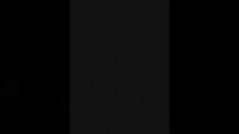 A video of a black vertical rectangle in a pitch-black background, creating a stark contrast and emphasizing its simple, minimalistic composition.