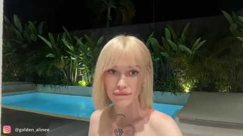 A CGI image of a blonde woman with straight hair, wearing a topless pose by a pool at night, surrounded by lush greenery and glowing lights.