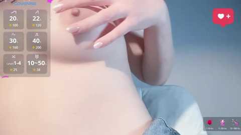 Video of a woman with fair skin, light pink bra, and blue jeans, with her hand covering her breast. Background features a blue gradient and social media icons.