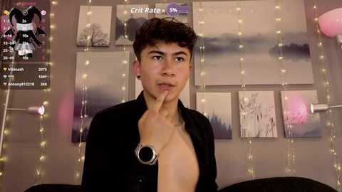 Video of a young man with curly hair, shirtless, holding his finger to his lips in a dark room with string lights, black and white artwork, and a \"CricRate\" overlay.