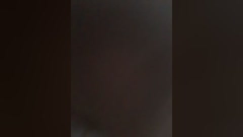 Video of a dark, blurry scene with indistinct shapes and colors, possibly depicting a night sky or urban landscape. The image lacks clear details or identifiable features, giving a sense of mystery and abstraction.