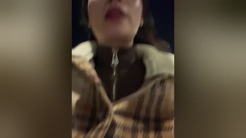 A close-up video of a woman's face, with a clear shot of her lips and chin, showing saliva dripping from her mouth, creating a blurred, textured effect.