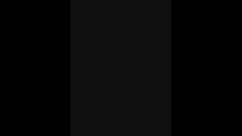 A digital image with a dark, black background and a vertical, slightly lighter black rectangle in the center, creating a minimalist, monochromatic visual effect.