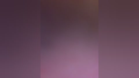 A blurred video of a purple gradient background with a slight vertical line. The image lacks distinct features, offering a soft, abstract visual effect.