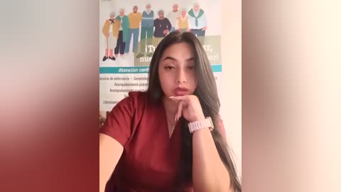 Media: A video of a young woman with long, dark hair, wearing a red top, resting her chin on her hand. Background features a poster of diverse seniors in casual attire.