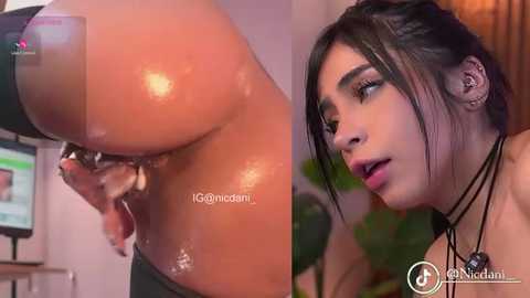 Video of a woman with light brown skin, dark hair, and black jewelry, in a BDSM setting, showing a large, shiny, wet breast with a nipple clamp, and a close-up of her expression.