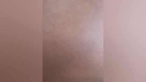 Video of a human buttocks, focusing on the skin texture and color, showing a light brown tone with slight variations, no clothing or additional objects visible.