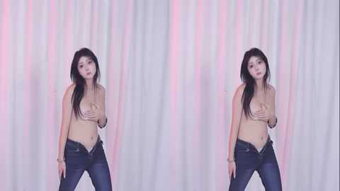 A side-by-side video of a topless East Asian woman with long black hair, wearing only dark jeans, posing against a white and pink curtain backdrop. She covers her small breasts with her hands.