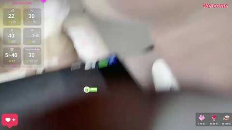 A blurry video shows a man's hand holding a smartphone, displaying a \"Welcome\" screen with options. The background is out of focus, and the image is slightly grainy.