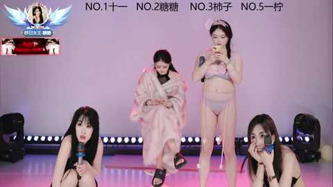 Video of three Asian women in lingerie, two holding microphones, on a stage with a white background, Chinese text above.