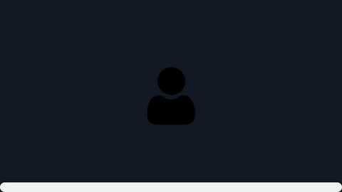 Video of a dark, featureless silhouette of a person, likely a man, against a deep blue background. The figure appears to be standing with arms by their sides, wearing a solid, dark-colored outfit. The image is minimalistic and lacks any additional details or objects.