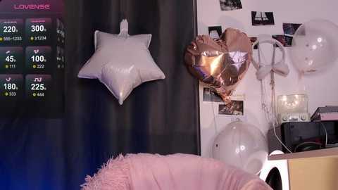 Media: A video of a cozy room with a pink fluffy chair, white star-shaped wall decoration, gold metallic balloon, and a colorful chart.