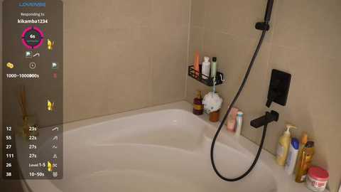 Video of a modern bathroom featuring a white bathtub with a black showerhead and various bath products. Background beige tiles, digital UI with stats, and a colorful emoji icon.