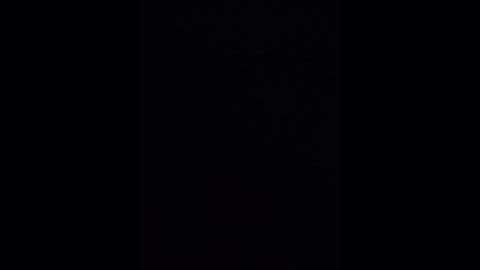 A video of a black background with a subtle, barely visible vertical line of lighter tone, suggesting a slight gradient or texture. The image is minimalist and monochromatic, evoking a sense of depth and simplicity.