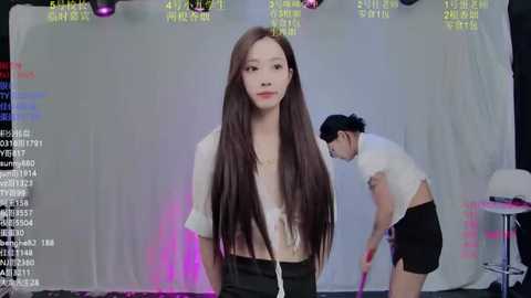 Video of two Asian women in casual attire against a white backdrop, featuring digital data overlays and studio lights.