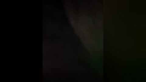 A dimly lit, abstract video with a dark, almost black background and a faint, ghostly figure of a person, possibly a man, partially visible in the center. The image is blurry and has a mysterious, eerie atmosphere.