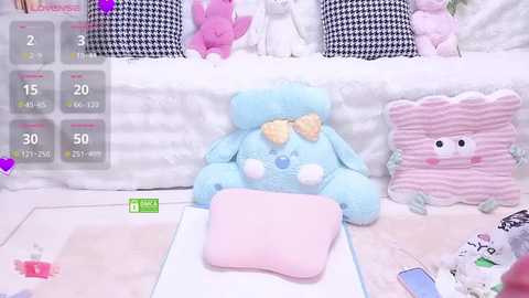 A video of a pastel-themed bedroom with plush toys, including a blue bunny, pink pillow, and a striped cushion.