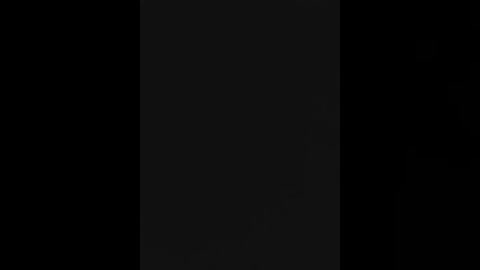Video of a black wall with a single vertical white line in the center, creating a minimalist, monochromatic design. The image has no additional objects, people, or textures, emphasizing simplicity and stark contrast.