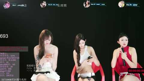 Video of three Asian women, seated, wearing casual outfits, holding smartphones, against a dark background, with text and social media icons in Korean.