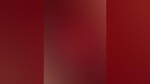 A digital image featuring a gradient of deep reds and browns, creating a smooth, seamless texture without discernible objects or figures. The composition is minimalist and abstract.