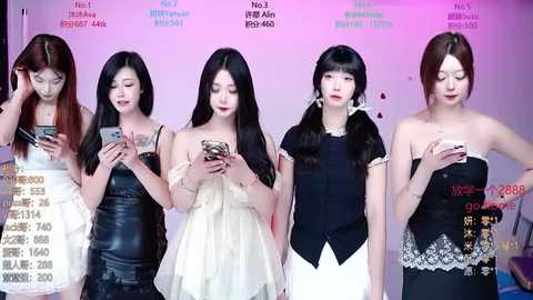 Video of five Asian women in various black and white dresses, standing in a row, checking smartphones, against a pink and purple backdrop with text.