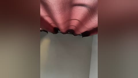 Close-up video of a person's nose, showing detailed nostrils, with blurred background of beige and gray colors. The image focuses on the nose's texture and skin tone, highlighting natural human features.