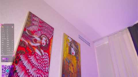 Video of a minimalist room with two vibrant, abstract paintings: one features a red, white, and black pattern, and the other a yellow, red, and white figure. A purple QR code watermark is visible in the bottom left corner.