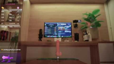 A video of a modern living room with a flat-screen TV displaying a video game, a pink dildo on the table, and a potted plant beside it.