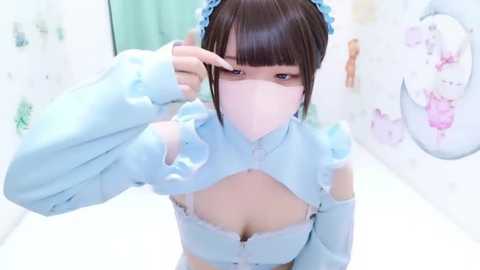 A video of an Asian woman with pale skin and straight black hair, wearing a light blue, frilled maid outfit, including a mask, with a playful expression and finger to her face, in a pastel-colored, whimsical room with floral wallpaper.