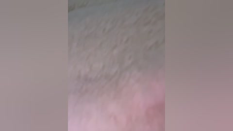 A close-up video of a pale, fuzzy, and unkempt armpit, showing a mix of light and dark hair, with no discernible facial features, set against a neutral, blurred background.