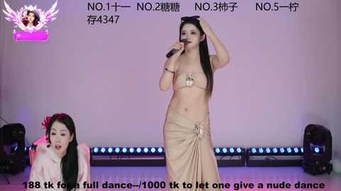 Media: Video of two women on stage, one in a gold bikini and the other in a red outfit, performing with microphones.