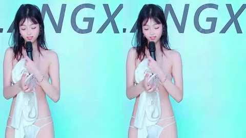Video of an Asian woman with long black hair, wearing only white lace panties, holding a microphone, singing into it. Background has the word \"NGXNGX\" repeated.