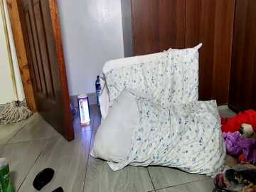 A video shows a chaotic bedroom scene with a rumpled bed, scattered clothes, and a partially opened door.