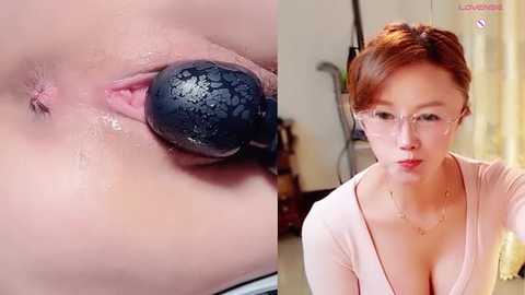 A video juxtaposes an extreme close-up of a woman's vulva with a black butt plug inserted, and a side view of the same woman wearing glasses and a low-cut top.