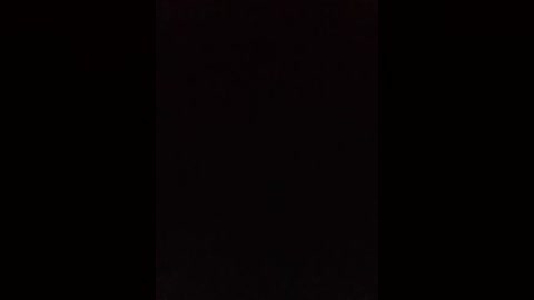 A digital image with a dark, black background. The image lacks visible details, suggesting a minimalist or abstract style. The overall tone is uniform and monochromatic, with no discernible objects or patterns.