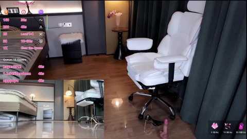 Video of a modern bedroom with white leather recliner, dark curtains, wooden floor, and a bed with a gray blanket. The room also features a desk and a lamp.