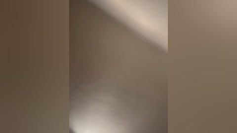 This is a video of an abstract, minimalist composition featuring soft, muted tones of beige and brown. The image showcases geometric shapes and subtle shadows, creating a serene and calming atmosphere.