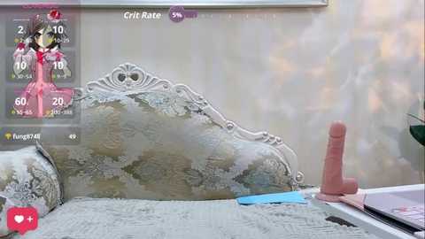 A video of a messy bedroom with a grey bedspread, a white headboard, and a realistic sex doll standing beside a laptop. A virtual \"Grit Rate\" and \"Crit Rate\" overlay appears on the left.