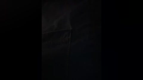 Video of a dimly lit, smoke-filled room with a faint, blurry figure in the background, possibly a person or an object, creating a mysterious, suspenseful atmosphere.